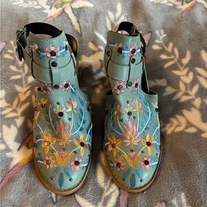 Teal open heeled booties with floral embroidery accents